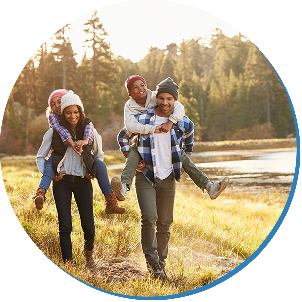 A group of people walking in the grass.